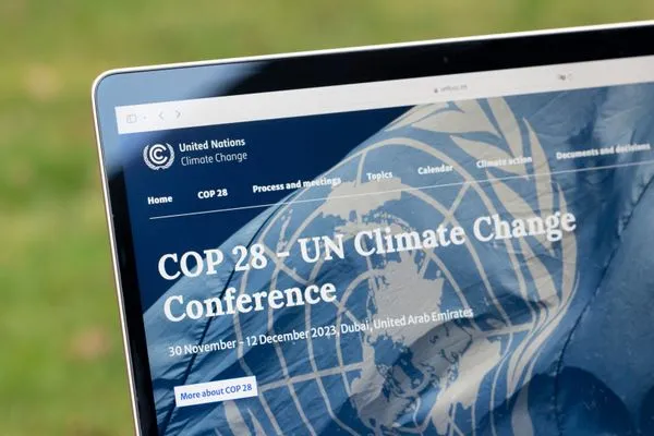 Laptop screen displaying COP 28 UN Climate Change Conference website, scheduled in Dubai from 30 November to 12 December 2023.